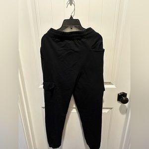 All black joggers, with white laces.